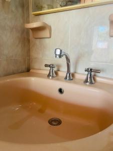 a sink with a faucet in a bathroom at Hostel Cerca al Centro Histórico in Cartagena de Indias