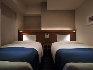 Ένα ή περισσότερα κρεβάτια σε δωμάτιο στο Keio Presso Inn Tokyo Station Yaesu