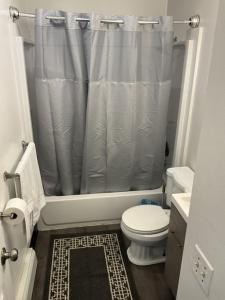 a bathroom with a shower curtain and a toilet at 410 e 45th ave unit 4 in Anchorage +23 photos