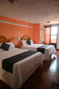 En eller flere senge i et værelse på Hotel Casa 12 Reales Guanajuato