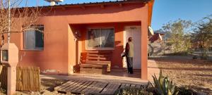 a person standing outside of a small house at La Casita de Seclantás in Seclantás