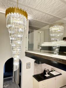 a kitchen with chandeliers hanging from the ceiling at Budapest Central Opera with Gym & Spa in Budapest