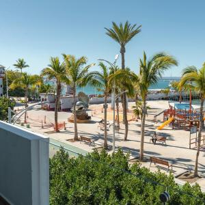 a beach with palm trees and a playground at Casa al Mar in La Paz