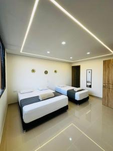 two beds are in a room with at Aero Hotel Boutique in Bogotá +36 photos