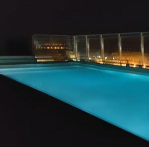 a swimming pool with blue illumination at night at PuertoNorteHome in Rosario