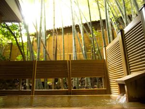 a wooden bench sitting in front of a building at Notoya in Komatsu