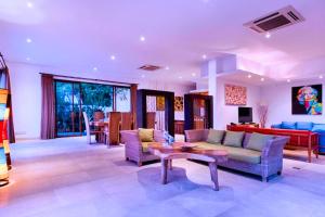 a living room with a couch and a table at Angkasa 5 BR Beachfront Villa JU31 in Keramas