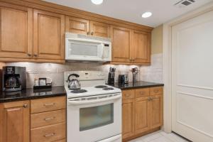 a kitchen with a white stove and a microwave at 2024 Beach Wood in Amelia Island
