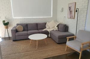 a living room with a couch and a table and two chairs at Perfect Large Multi Family Accommodation in Yarrawonga