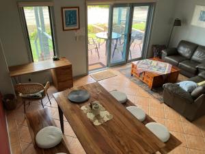 a living room with a table and a couch at Nosie 2 in Sawtell +8 photos