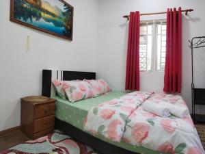 - une chambre avec un lit et des rideaux rouges dans l'établissement Z&S Homestay, à Gerik