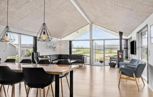 a dining room with a table and chairs at Five-Bedroom Holiday Home In Haderslev in Haderslev