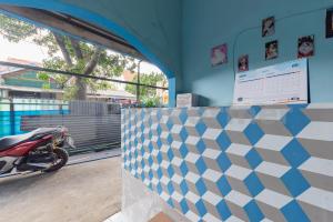 a motorcycle parked inside of a building with a wall at Grha Blue Sky Syariah RedPartner in Bandung