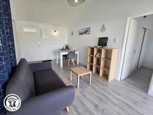 un salon avec un canapé et une table dans l'établissement Gîte 2 pers. proche plages et Marais Poitevin, terrasse couverte, tout inclus - FR-1-426-551, à Saint-Michel-en-lʼHerm 4 autres photos