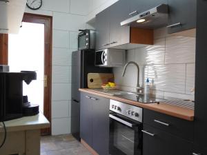 a kitchen with a stove and a sink and a counter at Elisa - L'Estartit, Centro - ES-323-85 in Torroella de Montgrí