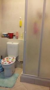 a bathroom with a toilet and a shower stall at شالية مميز للإيجار Porto golf بورتو جولف مارينا in El Alamein