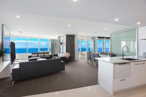 a kitchen and living room with a view of the ocean at Tallest Tower SkyHomes | 9 Hamilton Avenue in Gold Coast