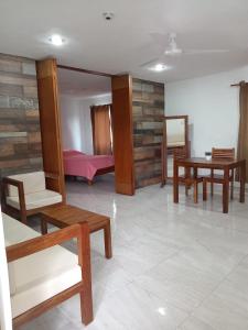 a living room with wooden furniture and a table at Túumben Ché Departamento 3 in Valladolid