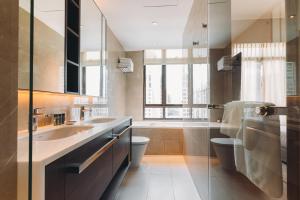 a bathroom with a sink and a toilet and a window at Great World Serviced Apartments in Singapore