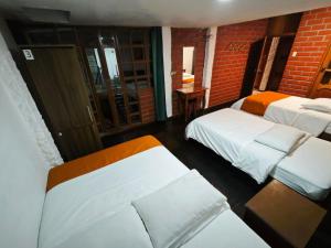 Ein Bett oder Betten in einem Zimmer der Unterkunft Garden House Hostal