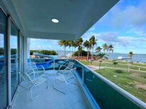 a balcony with a table and chairs overlooking the ocean at Puerto Marintusa in Tucacas