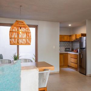 a kitchen with a table and a refrigerator at Casa al Mar in La Paz