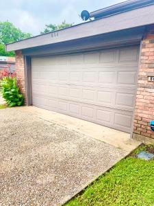 a garage door of a house with a driveway at Townhome with Hot Tub-Grand Ways Stay- Clarissa Pl in Garland +56 photos