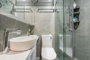 a bathroom with a toilet and a sink and a shower at Modern Single Room - AC - 1Min Walk to Central- Close to Darling Harbour Chinatown CBD - Shared Bathroom in Sydney +39 photos