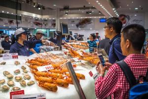 a group of people standing around a table with food at Modern Single Room - AC - 1Min Walk to Central- Close to Darling Harbour Chinatown CBD - Shared Bathroom in Sydney