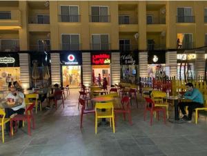 a restaurant with tables and chairs in a building at شالية مميز للإيجار Porto golf بورتو جولف مارينا in El Alamein
