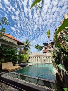 a swimming pool in the backyard of a house with a sky at Sampara Ubud with Mindrum Group in Ubud