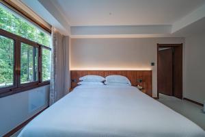 Postel nebo postele na pokoji v ubytování Fuxi-21 Homestay