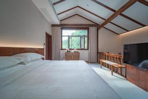 Postel nebo postele na pokoji v ubytování Fuxi-21 Homestay