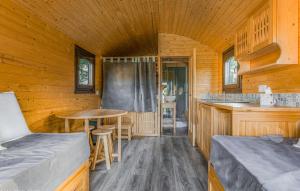 a cabin with a kitchen and a table in it at Cozy Home In Blancafort in Blancafort