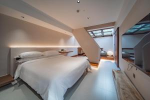Postel nebo postele na pokoji v ubytování Fuxi-21 Homestay