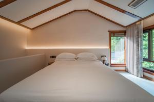 Postel nebo postele na pokoji v ubytování Fuxi-21 Homestay