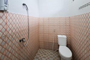uma casa de banho com um WC e um chuveiro em RedDoorz at Kampung Istal Bogor em Jakarta