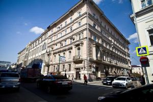 a large building with cars parked in front of it at Kvart-Hotel Estrella in Moscow