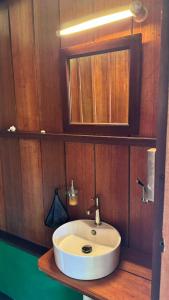 a bathroom with a white sink and a mirror at Nyande Raja Ampat in Pulau Mansuar