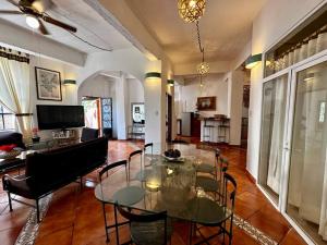 a living room with a glass table and chairs at Rinconada in Taxco de Alarcón