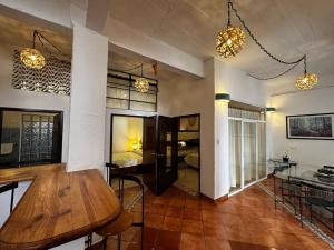 a living room with a wooden table and a dining room at Rinconada in Taxco de Alarcón