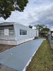 a mobile home is parked on a driveway at 1161 Studio 2 Miami in Tamiami