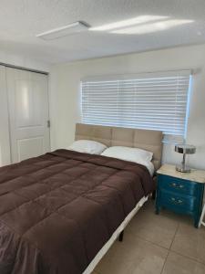 a bedroom with a large bed and a window at 1161 Studio 2 Miami in Tamiami