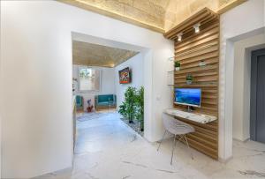 a room with a desk and a computer on a wall at Andromeda Hotel in San Vito lo Capo