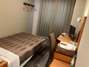 Tempat tidur dalam kamar di Racine Shinmaebashi