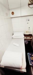 Ένα ή περισσότερα κρεβάτια σε δωμάτιο στο Four Seasons Hostel