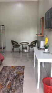 a room with chairs and a table and a table at Zaz cottage Langkawi in Pantai Cenang +3 photos