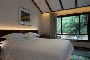 Postel nebo postele na pokoji v ubytování Fuxi-21 Homestay