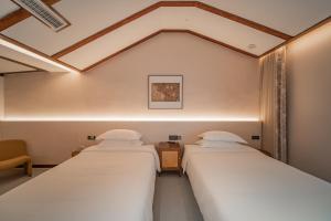 Postel nebo postele na pokoji v ubytování Fuxi-21 Homestay
