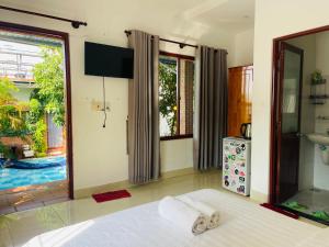 a bedroom with a bed with towels on it at Mui Ne Garden Hotel and Kite School in Mui Ne